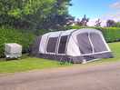 This is were we was pitched carvan across from us toilets behind the big tree .