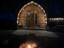 The log cabin with pretty lights whilst having a fire