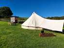 The bell tent, with cookshack and outdoor seating.