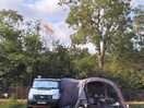 The campervan on grass pitch with awning and electric