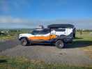 Neighboring adventure vehicles and film crew.