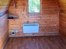 Inside the camping pod. there is a heater and a little window at the end of the pod.
