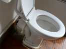 Broken toilet with water coming from back