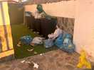 Weeks worth of smelly rubbish piled between gate and the empty reception