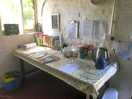 Bench in the store with books, notices, kettle, somewhere to charge phones…
