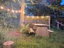 Outdoor seating area with firepit and fairy lights