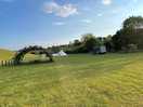 Shared picnic tables. lots of space and fire pits ready and included in the price. logs on site.
