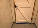 Gap under toilet and shower room doors, leading to outside.
