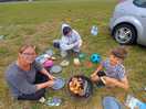 Family around the campfire cooking