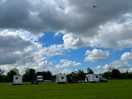 Bi-plane flying over campsite