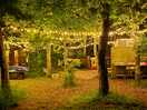Fairy lit area with games, benches, toilets, showers, washing up area, bins, information centre/shop