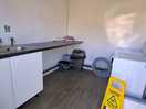 Utility room, including washing machine and dryer.
