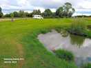 Spacious site with small pond.
