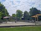 View from the pool of the petanque courts with the bar and reception building in thr background