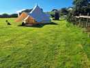 Bell tent with cookshack behind.