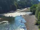 Directly by the river