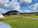 This is the rear of the black barn with a beautiful covered eating area overlooking the campsite