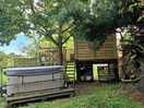 Garden area of treehouse pod with hot tub