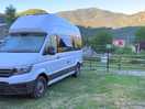 Photo of our camper with the mountains behind