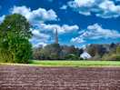 View across the fields at the rear of the site looking at the spire of tydd st mary church.