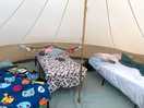 A clean tent with comfy beds