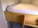 Bunk beds at the rear of the pod, with storage, clothes rail opposite