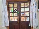 Door out of bathroom with curtains open.