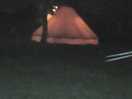 The bell tent all lit up at night.