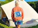 Posing with bell tent and ‘surf every wave’ jumpier by lotus surf co.