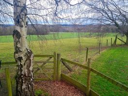 Gorgeous view out into the fields with the seating area for two visible on the right