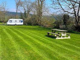 A spacious grass pitch for tents, motorhomes and campervans.