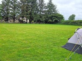The pub is beyond the trees as are the toilets/showers.