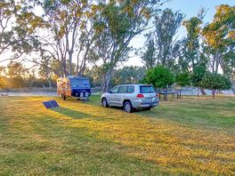 Camping area along the tree-lined river