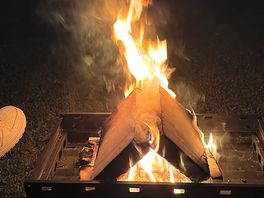 Fire by the tent at night