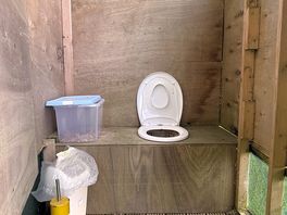 Compost toilet. coverband on seat.