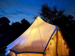 Bell tent at night lovely lights and fairy lights inside