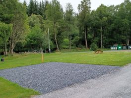 Hardstanding pitch with grass to the side