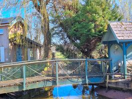 Jack's den on left and bench to sit on by walking across a bridge for anyone.