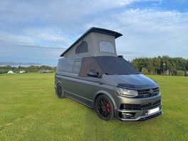 Vw campervan with pop-top up overlooking oxwich bay