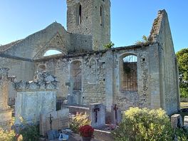The ruined church next to a farm