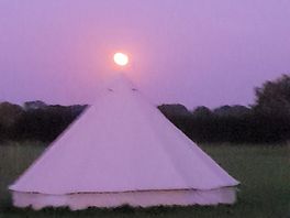 Harvest moon over one of the sites bell tents.