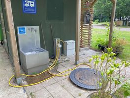Fresh water hose lying on the ground adjacent to the chemical disposal point!