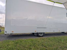 Large trucks parked right next to our campervan and awning.