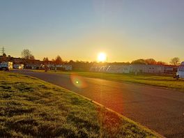 Sunset over the static site and housing estate.