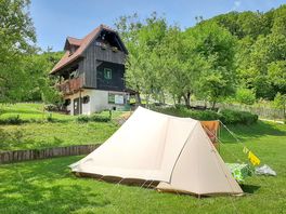 Grassy pitches next to traditional houses