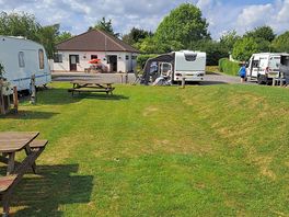 Grassed area, reception toilet shower block to the left