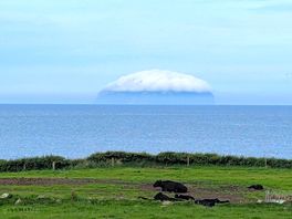 Ailsa craig in firth of clyde, off west coast of scotland; early morning with its hat on!
