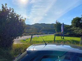View up the hill toward the reception area from the parking bay near the lower field