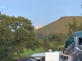 Moon peaking over the hills