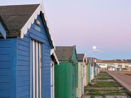 Colourful beach huts along promenade